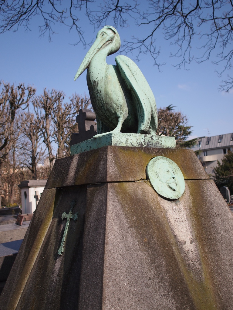 Unusual grave topped with a pelican, a symbol of devotion and piety